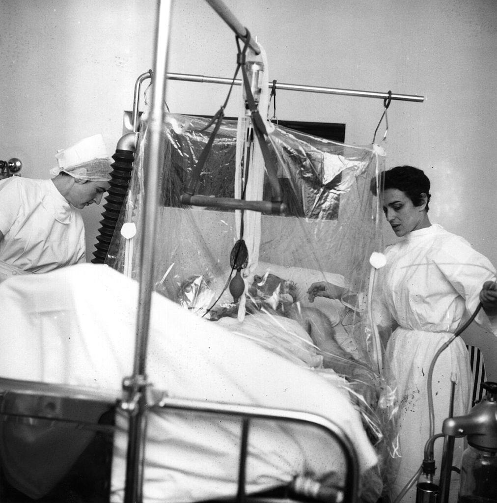 Sir Matt Busby (1909 – 1994), football manager of Manchester United, lying in hospital in an oxygen tent after the Munich air crash, 13th Feb 1958.