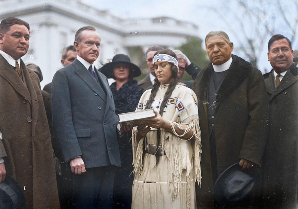 #11 This Native American woman, center is meeting US President Calvin Coolidge in 1923 in advance of the Indian Citizenship Act.