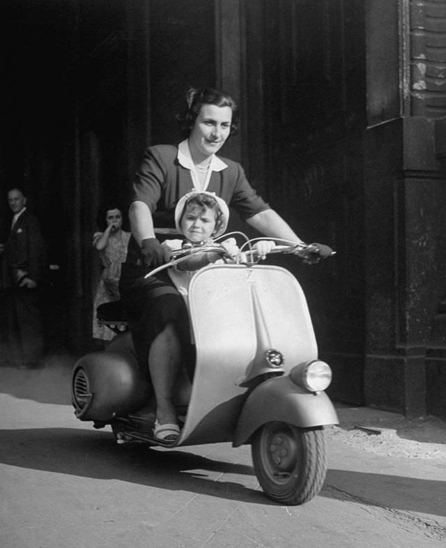 #11 A mother and her baby on a Vespa.