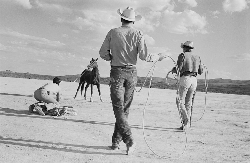 Clark Gable, Eli Wallach and Montgomery Clift roping a horse on location in the Nevada Desert during the filming of ‘The Misfits’.