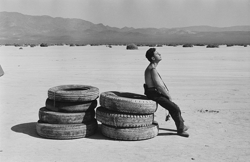 Magnum photographer Elliott Erwitt resting in the sun during the filming of ‘The Misfits’ on location in the Nevada Desert.
