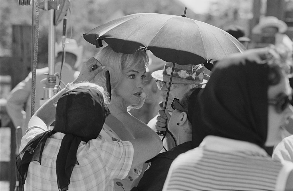 Marilyn Monroe is surrounded by attentive women on the set of John Huston’s ‘The Misfits’