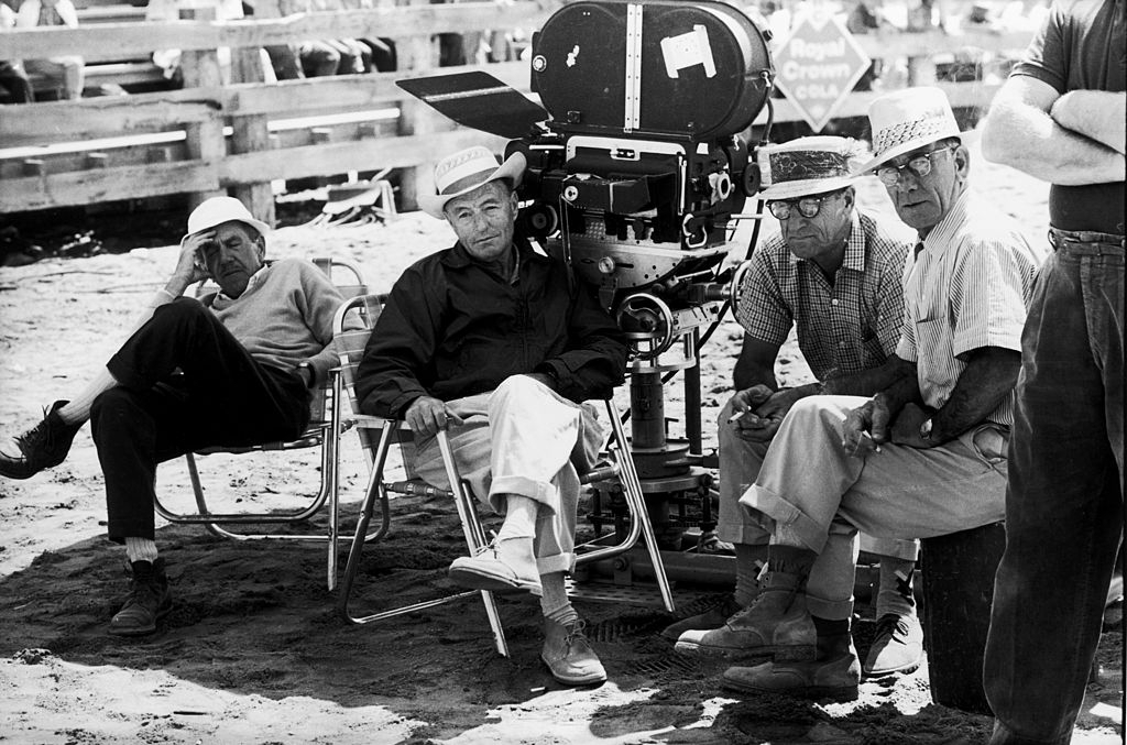 A group of crew members resting in the shade on the set of John Huston’s ‘The Misfits’