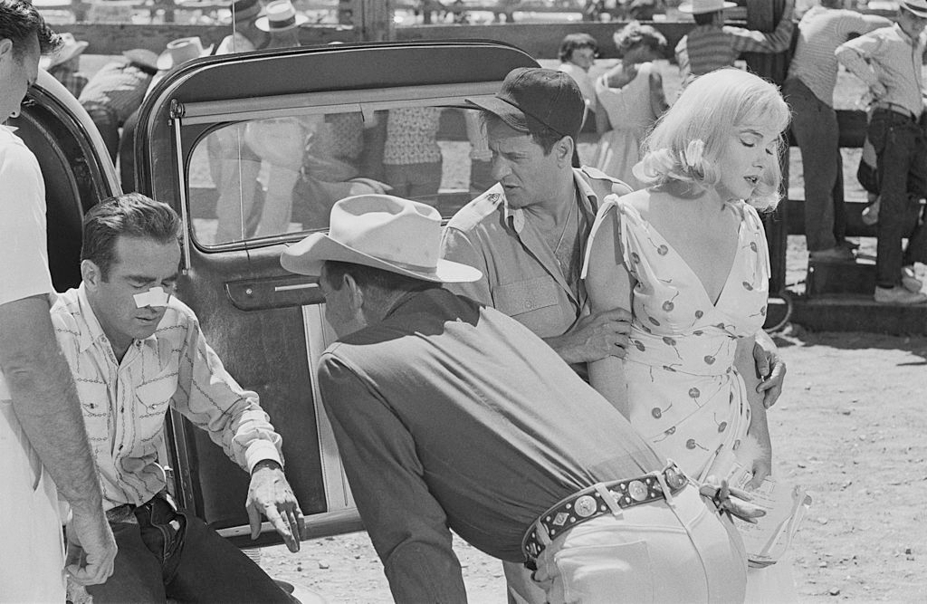Clark Gable examines Montgomery Clift’s broken nose whilst Eli Wallach looks after Marilyn Monroe in a scene from ‘The Misfits’
