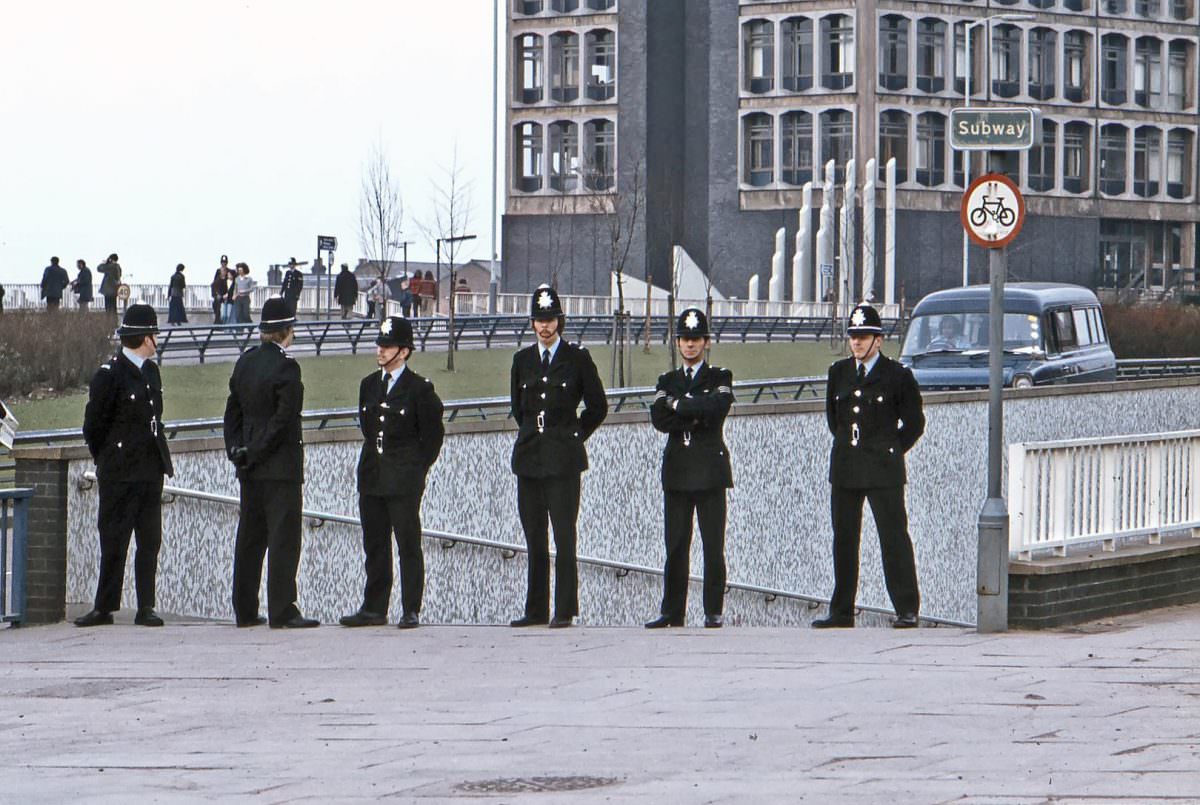 #25 A group of policemen wait on Wolverhampton ring road prior to the passing of an anti-racist demonstration procession. 11th March 1978