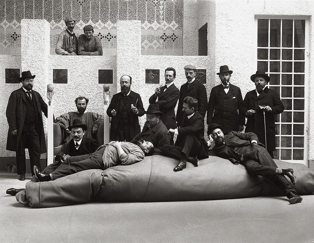#23 Group portrait of the artists of the Viennese Secession. Gustav Klimt in his pinafore and Kolo Moser sitting in front of Klimt. Austria, 1902.