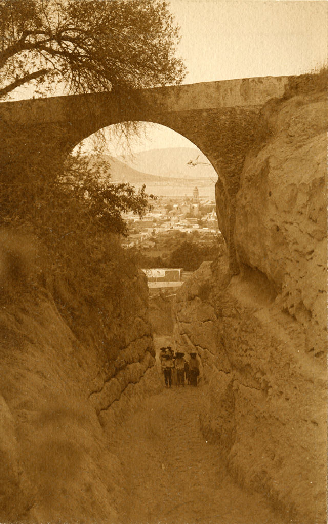 #11 Men standing under stone archway Atlixco. Puebla, 1907