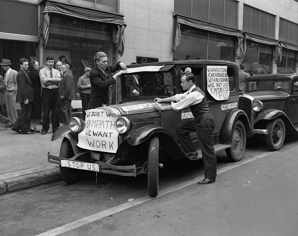 #16 Job seekers during the Great Depression have put signs on their car expressing their wish to work. Minneapolis, 1930.