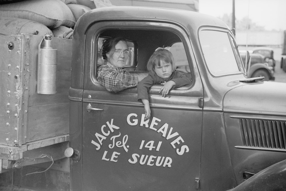 #29 Family of trucker waiting while truck is being loaded, Minneapolis, 1930s.