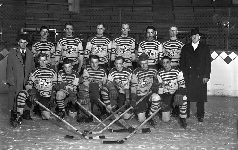 #42 The amateur hockey team from the Flour City Coal and Oil company pose on the ice with their coaches in 1934.