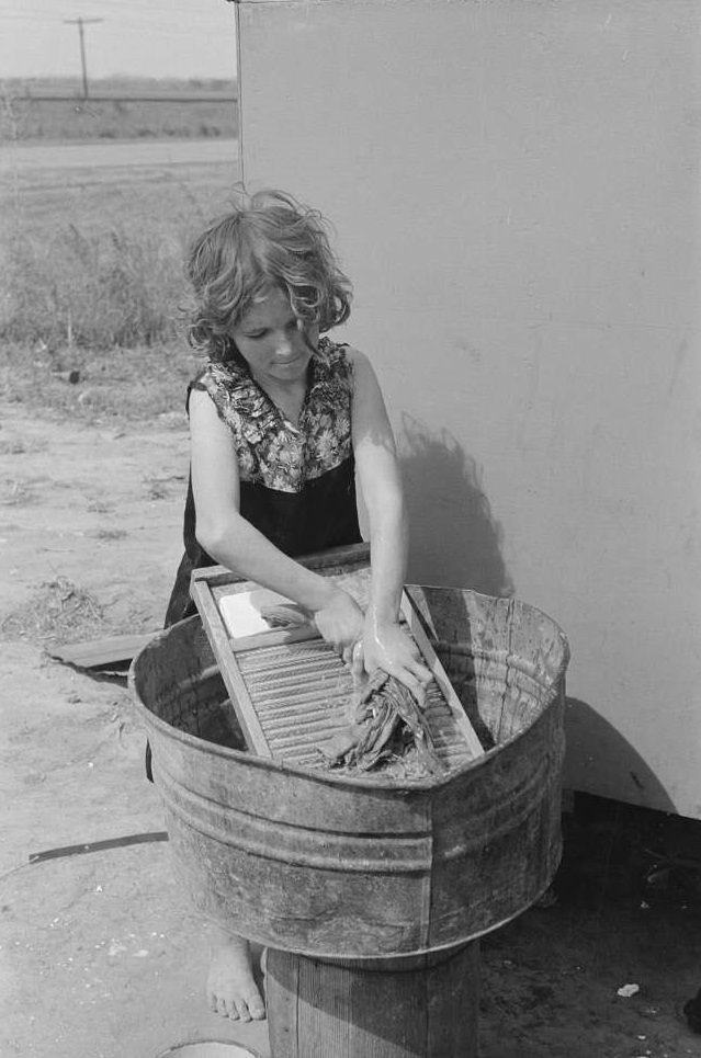#6 Twelve-year-old girl who keeps house in a trailer for her three brothers who are migrant workers, near Harlingen, Texas, February 1939.