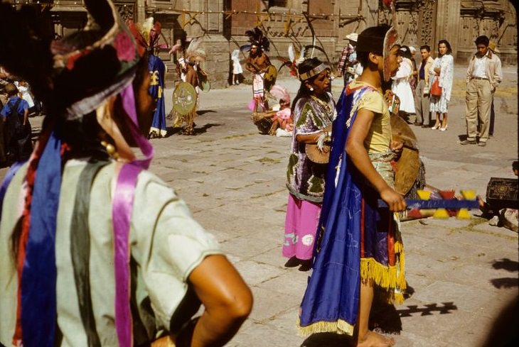 #45 Indians in regalia, preparing for performance in plaza, 1950s