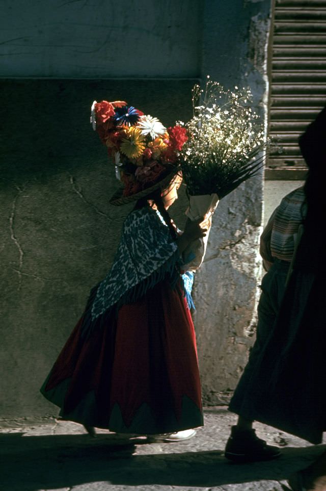 #27 A child carrying bouquet on her way to the fiesta, 1968