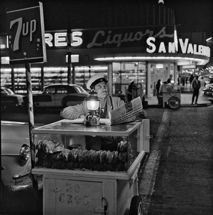 #8 Taco vendor in Tijuana, Mexico, catching up on the day’s news until the next customer shows up, 1964