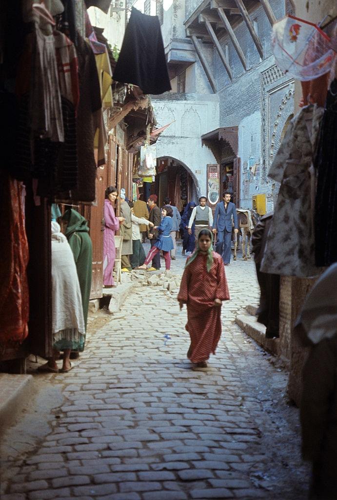 #1 Girl walking down a city street. Marrakech, 1960.