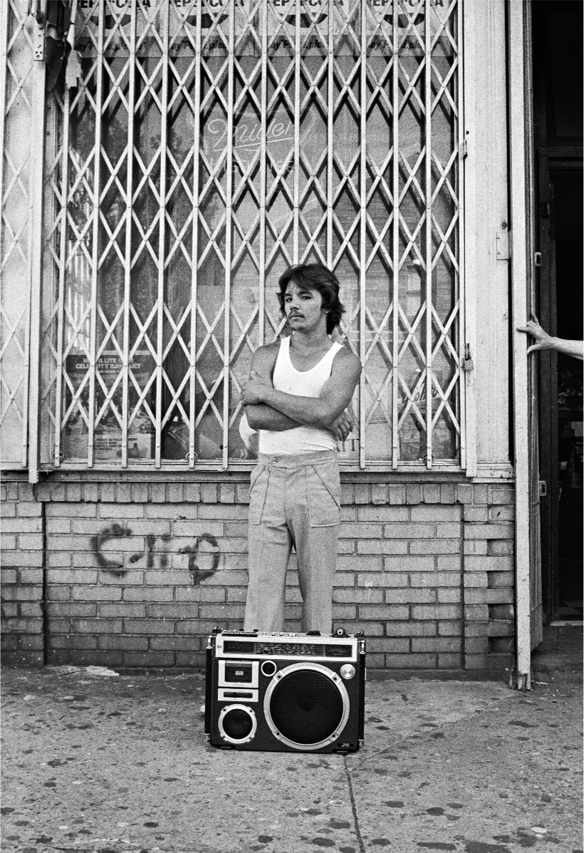 #54 A young man with a BoomBox on 18th Street, 1970s.