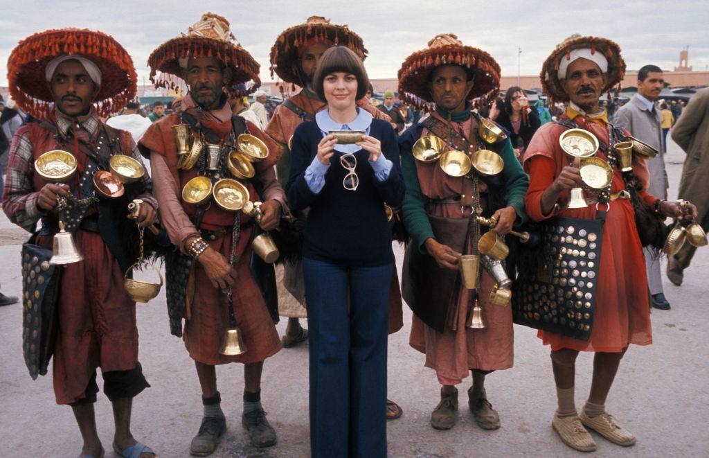 #6 Mireille Mathieu surrounded by men in traditional dress in May 1976 in Morocco.