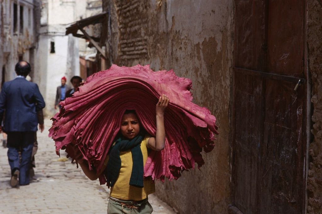 #15 Young boy carrying animal skins, 1978.