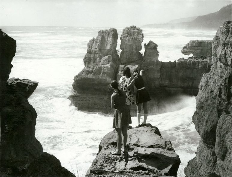 #13 Punakaiki, Nelson Province. Looking North. Girls on the Stratified rock formation high above the sea, February 1972