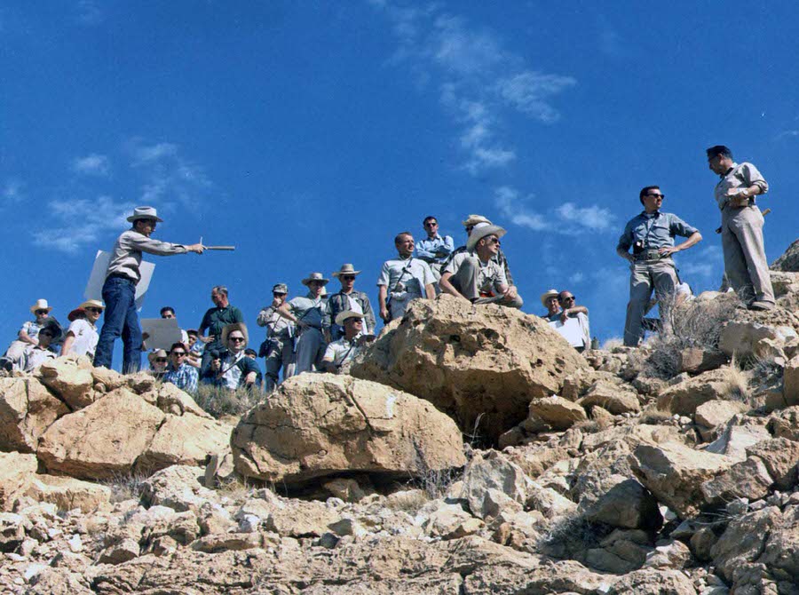#19 The astrogeologist Gene Shoemaker describes the geology of the rim ejecta of Arizona’s Meteor Crater to a large group of astronauts during a field trip in May 1967.
