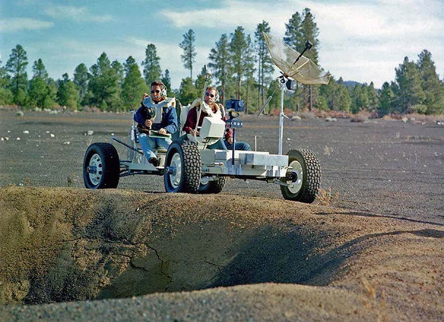 #20 The astronauts Jim Irwin and Dave Scott pilot Grover near the rim of a large crater in the Cinder Lake Crater Field.