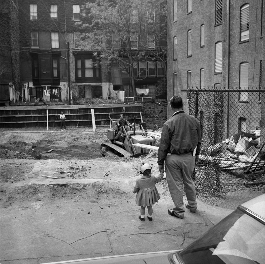 #7 A father and daughter watch construction in Brooklyn Heights, March 1958.
