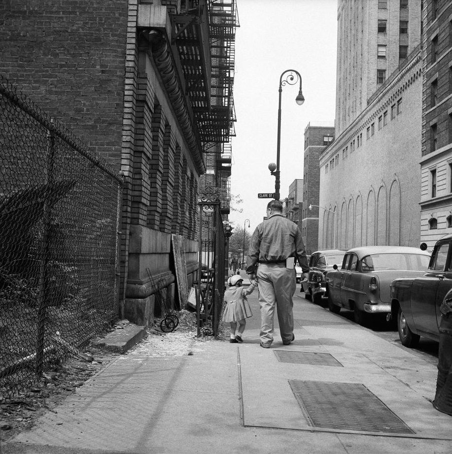 #8 A father and daughter walk near Clark Street in Brooklyn Heights, March 1958.