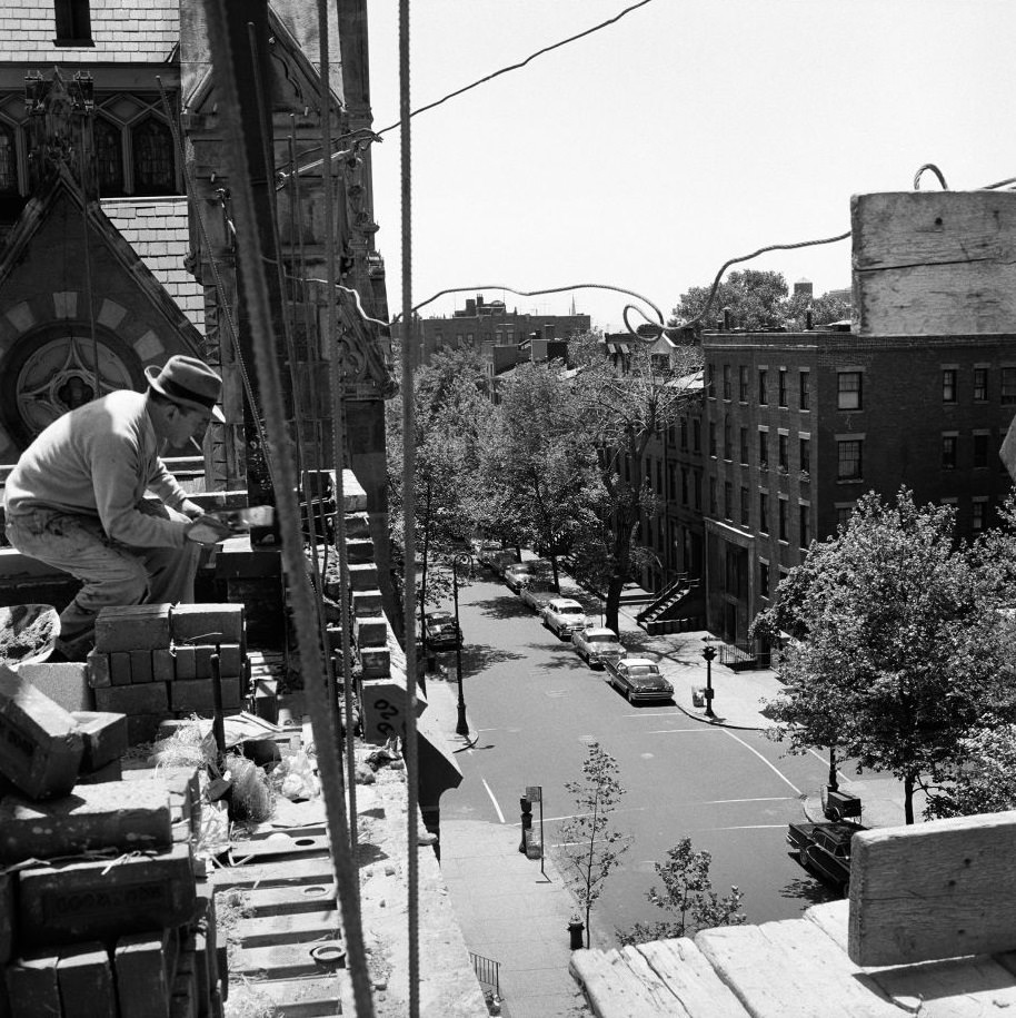 #32 A construction worker takes a cigarette break on a building-in-progress in Brooklyn Heights, March 1958.