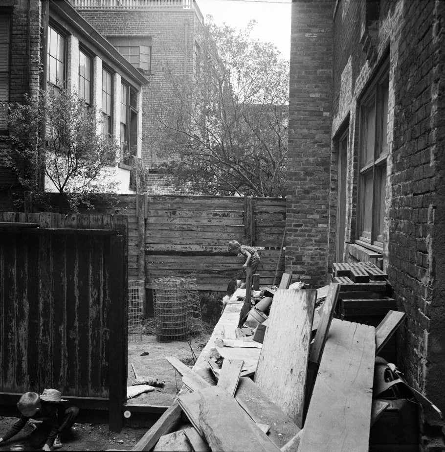 #49 Children play with construction materials in an alleyway in Brooklyn Heights, March 1958.