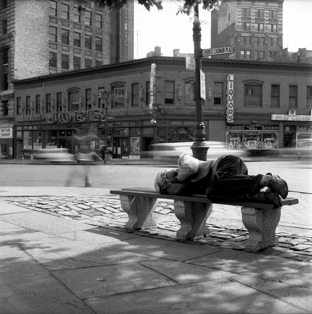 #37 A homeless man sleeps in front of Joe’s Restaurant on Fulton Street in Brooklyn Heights in March 1958.