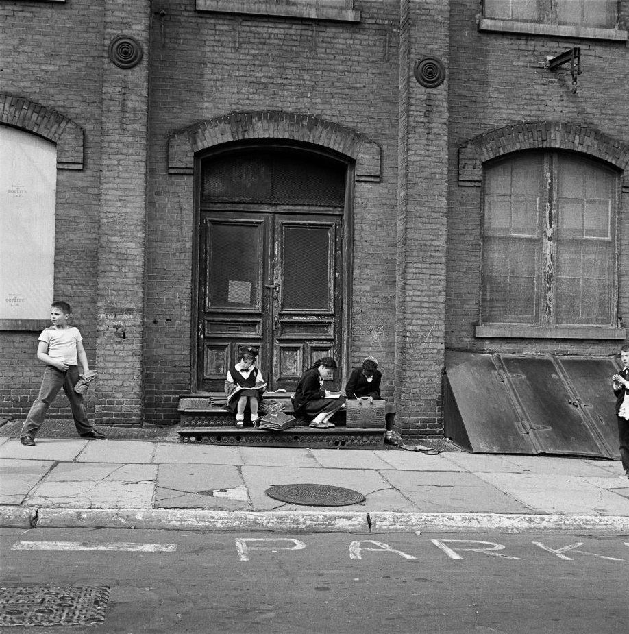 #53 An ethnically diverse group of school children do their homework in Brooklyn Heights, March 1958.