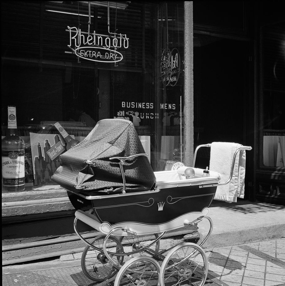 #41 A baby carriage idles outside Kelly’s Bar, at 13 Atlantic Avenue in Brooklyn Heights, March 1958.