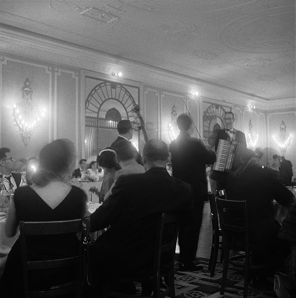 #61 Guests at a wedding reception listen to the band in Brooklyn Heights, March 1958.