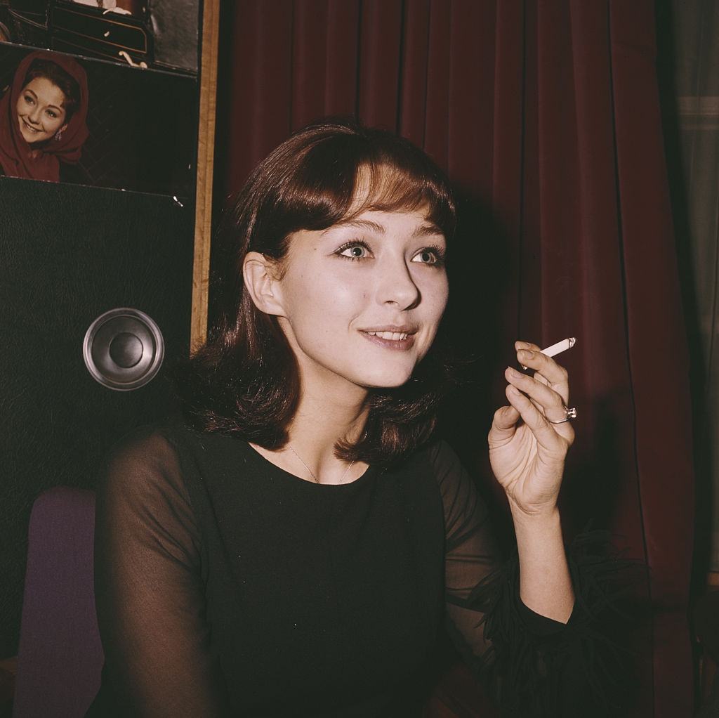 #33 Christine Kaufmann smoking a cigarette in London in 1962.