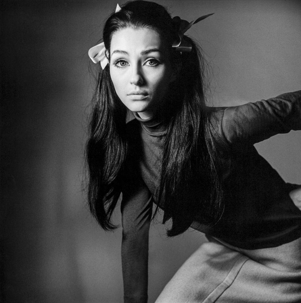 #38 Christine Kaufmann wearing dark turtleneck and light skirt.