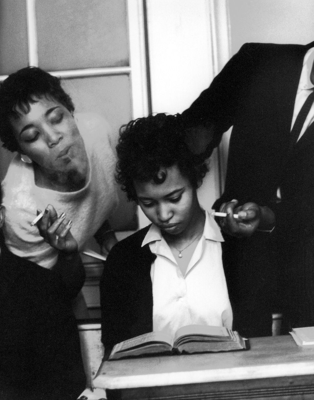 #9 Eve Arnold being trained to not react to smoke blown in her face, 1960.