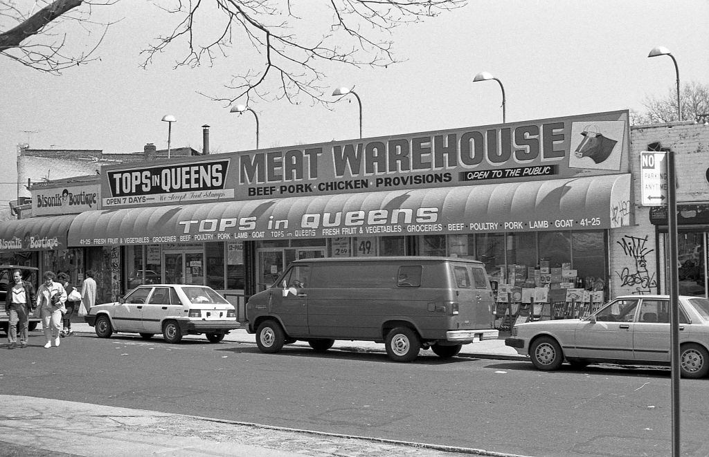 #12 Veteran’s Square park (at the intersection of 102nd and National streets with 42nd Avenue) of various businesses along 102nd street, in the Corona neighborhood. Queens, New York, 1990.