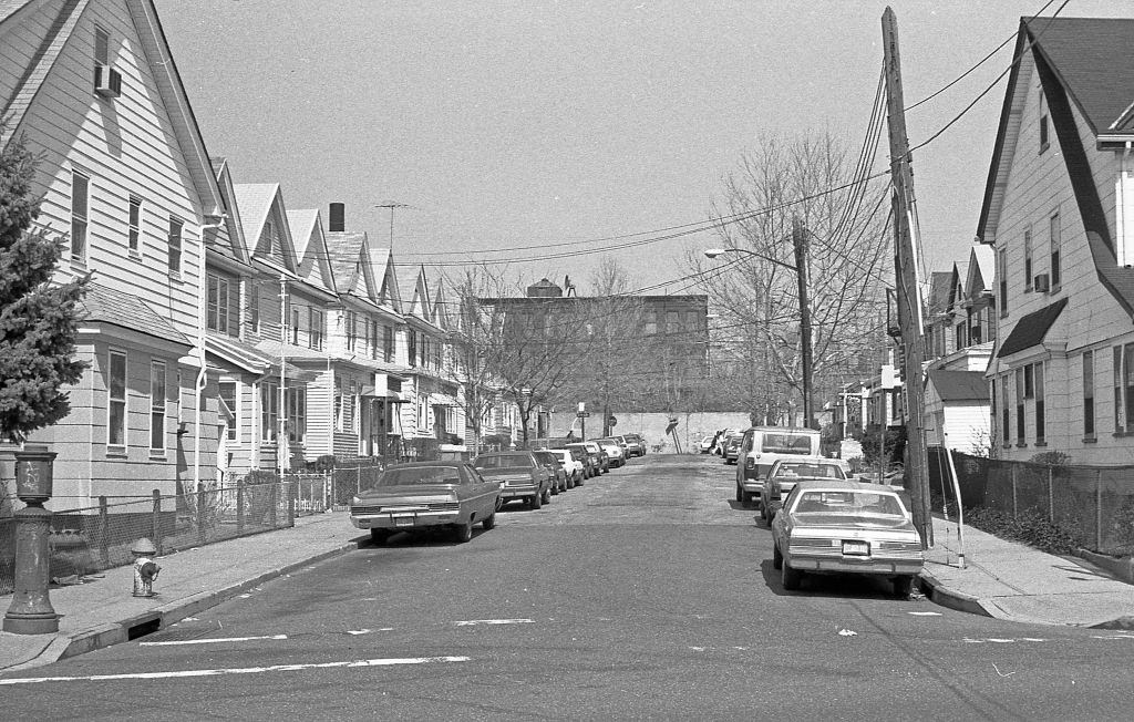 #16 Looking north along 97th Place, of a line of residential homes, in the Corona neighborhood. Queens, New York, 1990.