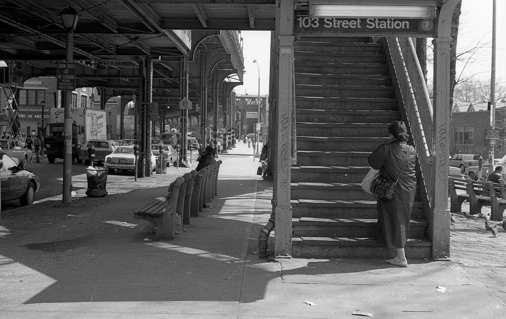 #5 A commuter walking up the staircase to the elevated subway on Roosevelt Avenue (at 103rd Street), in the Corona neighborhood. Queens, New York, 1990.