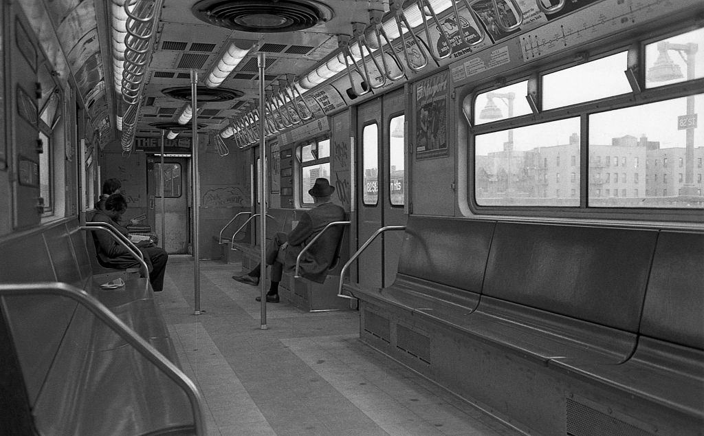 #3 Three commuters sit in a graffiti covered subway car as it travels through Corona, Queens, 1974.