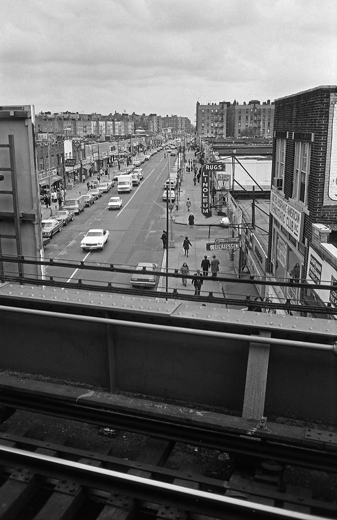 #5 Elevated view from the Seven Train Subway platform of small businesses lining Roosevelt Avenue in the heart of Corona, Queens. 5th November 1974