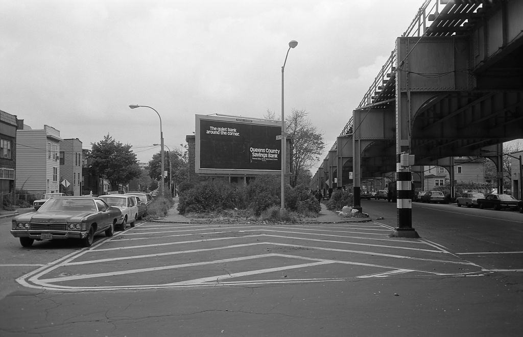#17 Residential homes next to the elevated subway line at 39th Avenue in Corona, Queens, 1974.