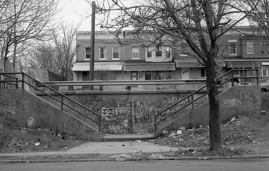 #3 Dilapidated and graffiti-covered cement staircases that lead to a row of residential homes on 37th Avenue (near 110th Street) in Corona. Queens, New York, 1982.