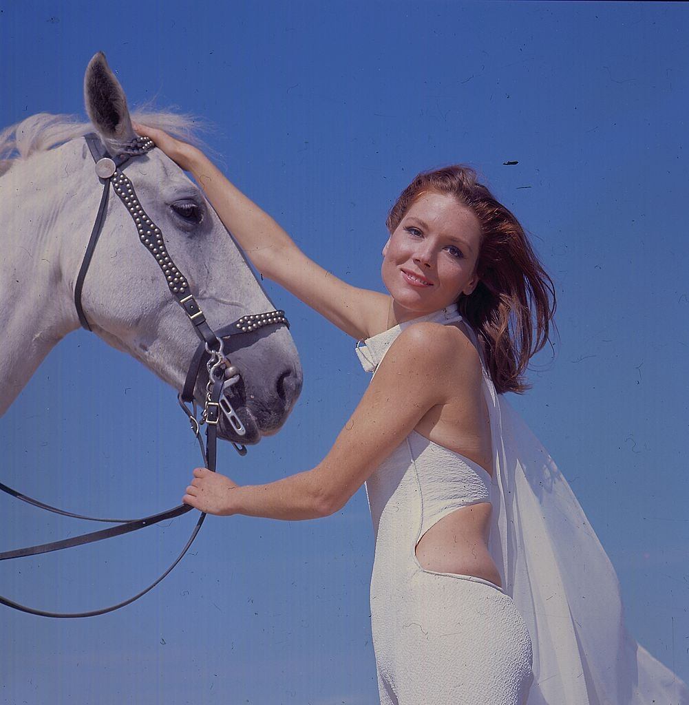 #35 Diana Rigg with a white horse on Camber Sands, 1967.