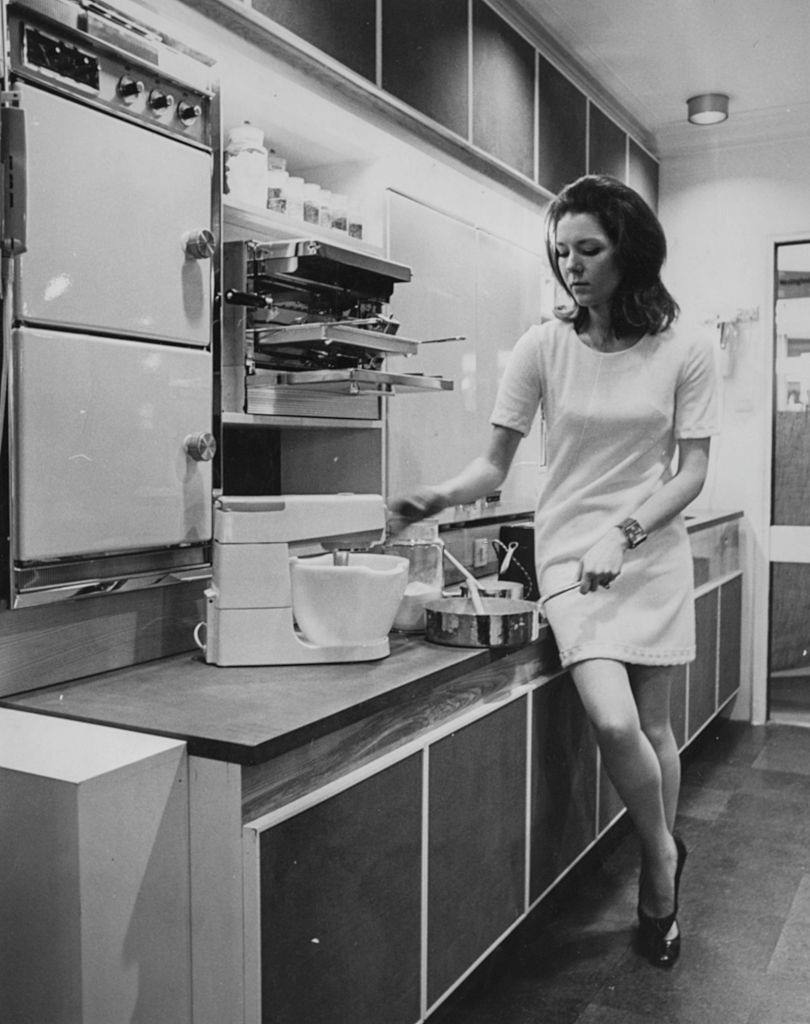 #38 Diana Rigg trying out a new cook’n dining room ‘ in the electric pavilion at the Daily Mail Ideal Home Exhibition, 1967.