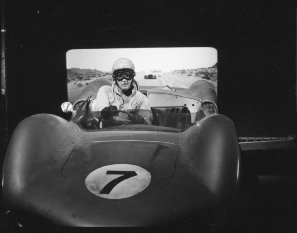 #16 Elvis behind the wheel of a 1962 Elva Mk. VI with a video backdrop comes from the filming of 1964’s Viva Las Vegas.