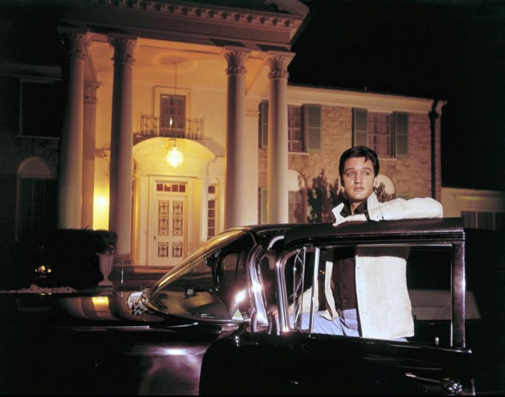 #17 Elvis poses with one of his cars outside of Graceland, his mansion in Memphis, Tenn.