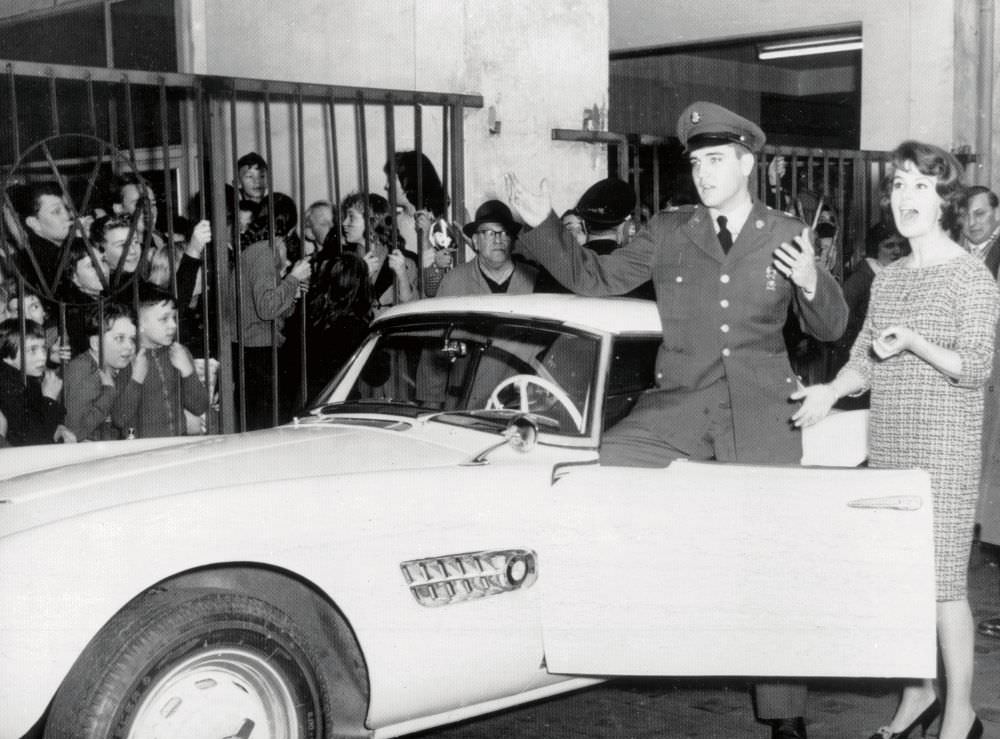 #9 Elvis with his BMW 507 and local TV personality Uschi Siebert in Germany, 1958.