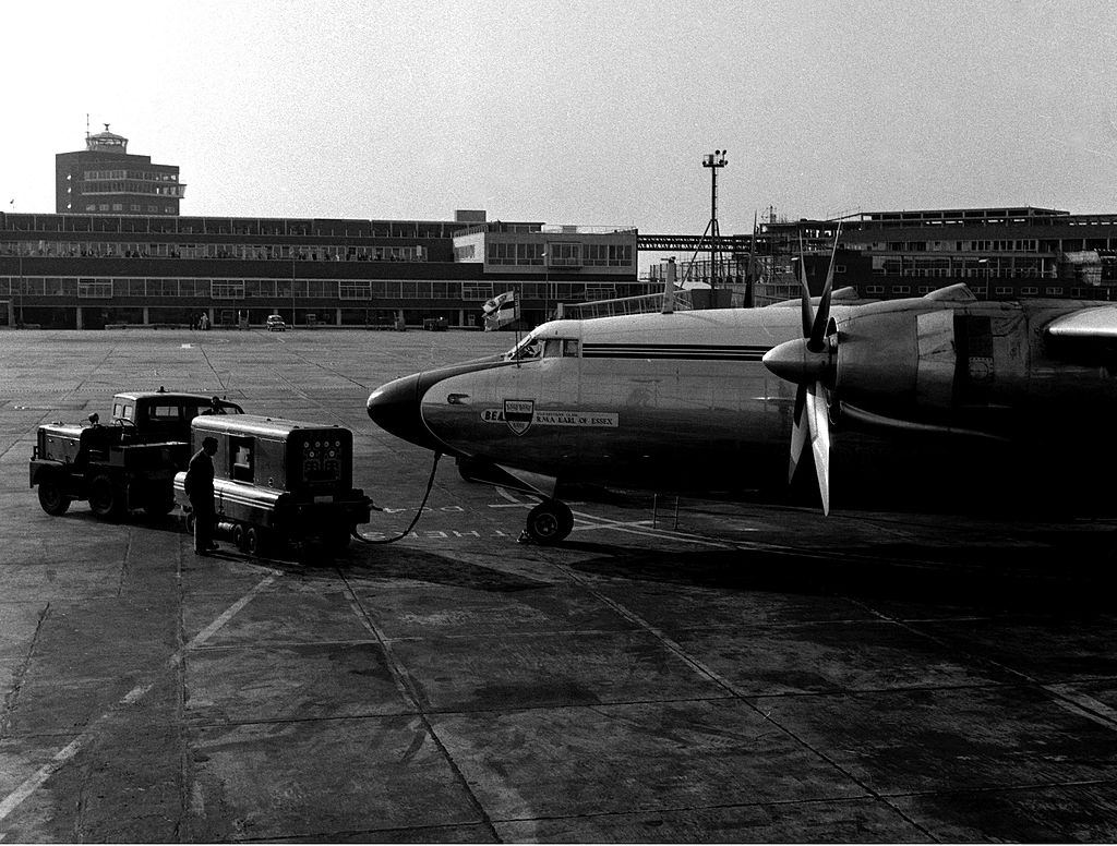 #13 Servicing wagons prepare to pull away from the plane waiting on the tarmac. 9th June 1955.