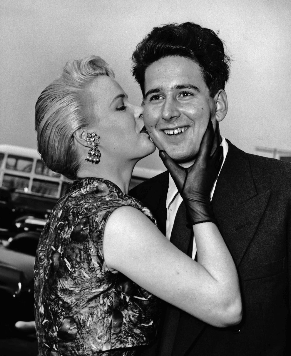 #35 Lord Anthony Moynihan, 3rd Baron Moynihan, is greeted on arrival at Heathrow by ‘Miss Calypso of 1957’ Julia Martin, 1957.